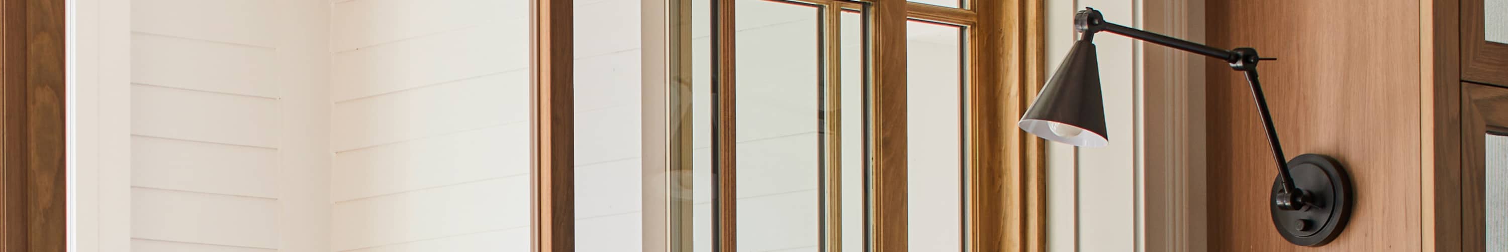 Oil rubbed bronze task sconce next to a window